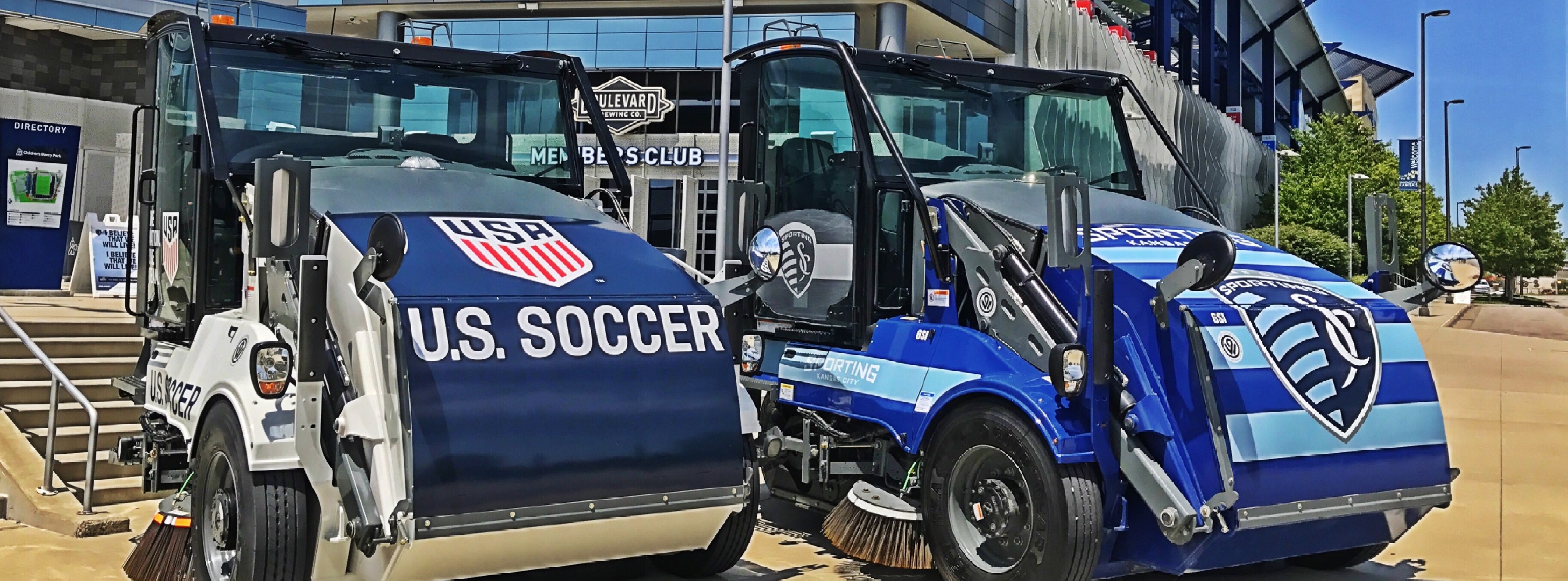 A photograph of Public Works Street cleaners parked in front of Sporting KC.