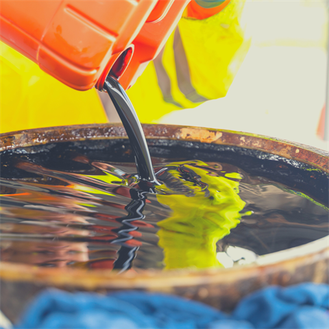 Photo of used oil being poured into a container at a Household Hazardous Waste Disposal event